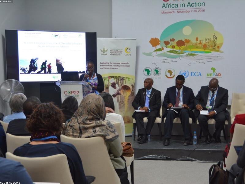 African smallholder farmer discussing micro-financing options on a digital tablet.